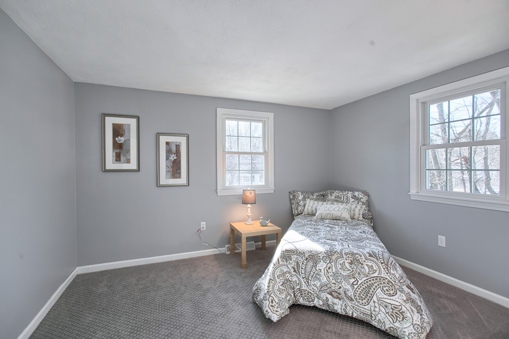 6 Campbell Road Billerica, MA 01821 - Photo 18 of 30 a bed sitting in a bedroom next to a window