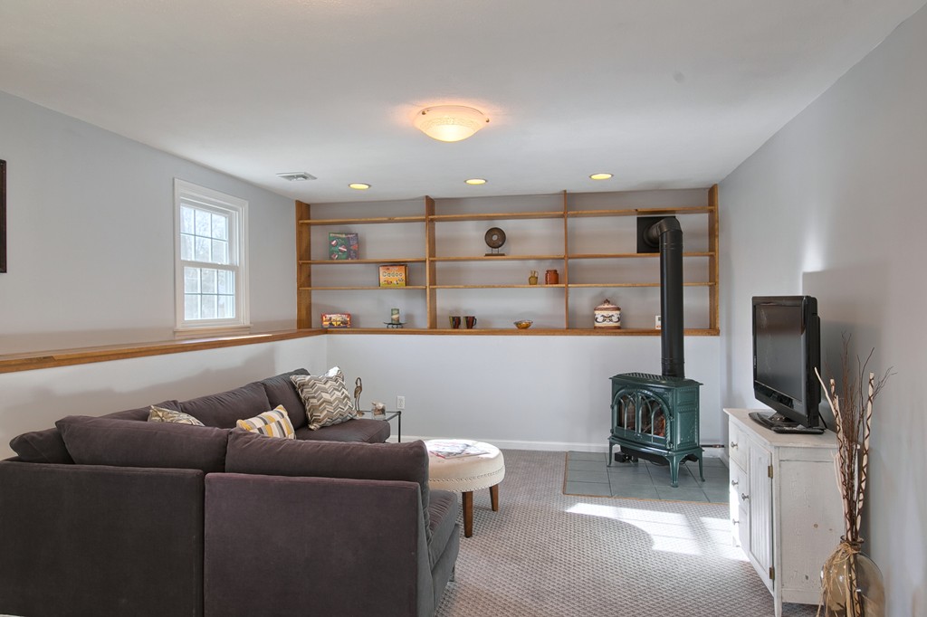 6 Campbell Road Billerica, MA 01821 - Photo 24 of 30 a living room with furniture and a flat screen tv