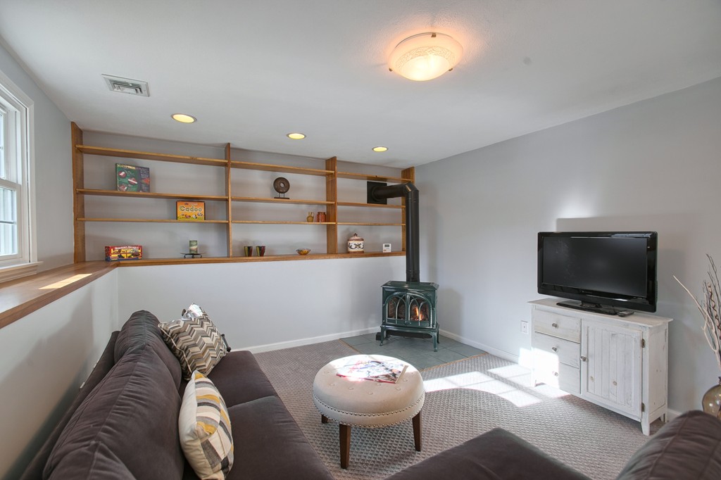6 Campbell Road Billerica, MA 01821 - Photo 27 of 30 a living room with furniture and a flat screen tv