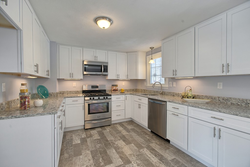 6 Campbell Road Billerica, MA 01821 - Photo 6 of 30 a kitchen with granite countertop white cabinets and stainless steel appliances