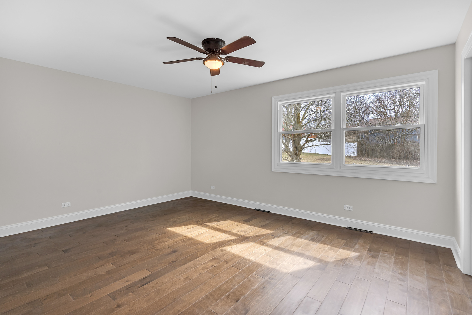 410 Kickapoo Avenue Batavia, IL 60510 - Photo 11 of 25 a view of empty room with wooden floor and fan