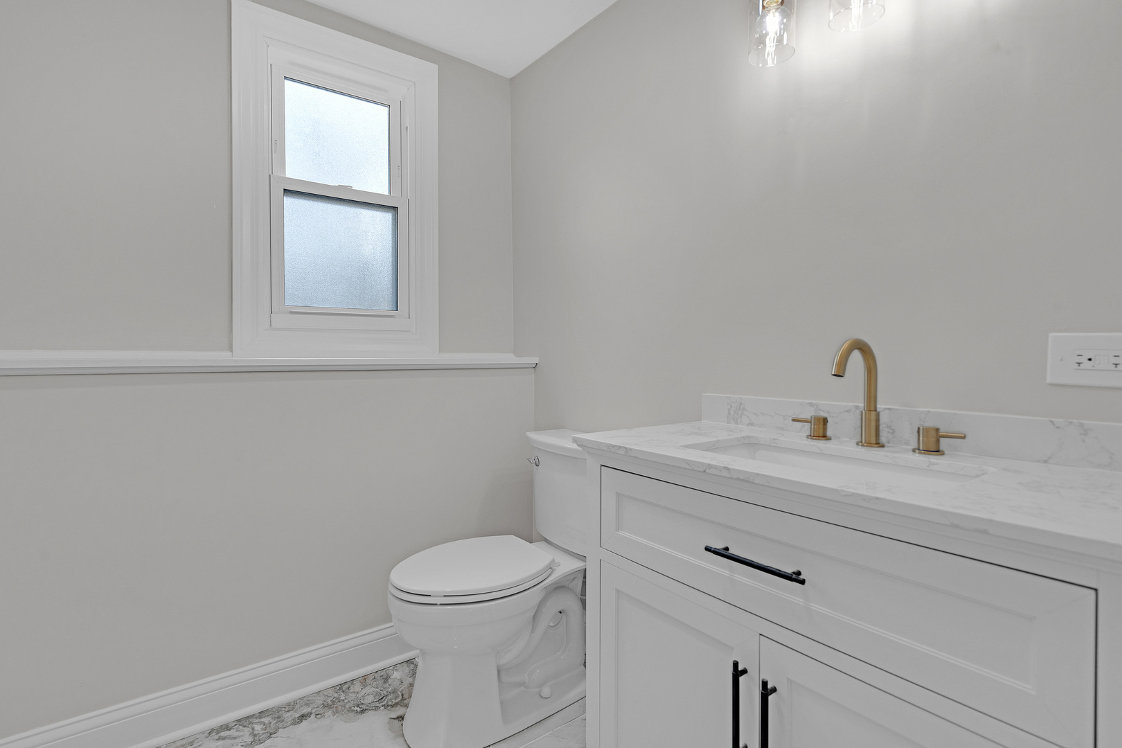 410 Kickapoo Avenue Batavia, IL 60510 - Photo 14 of 25 a bathroom with a toilet sink vanity and window