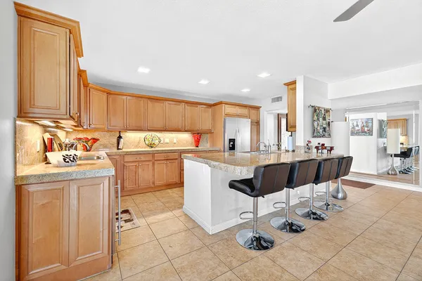 a kitchen with stainless steel appliances granite countertop a sink dishwasher stove and cabinets with wooden floor