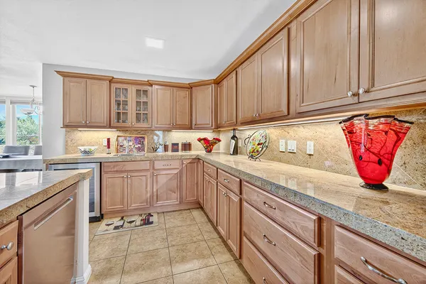a kitchen with stainless steel appliances granite countertop a sink and cabinets