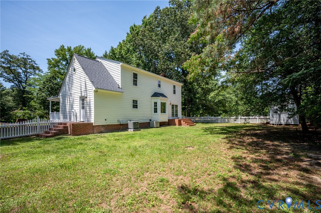 10110 Holly Road Mechanicsville, VA 23116 - Photo 3 of 26 Spacious backyard featuring a white picket fence,