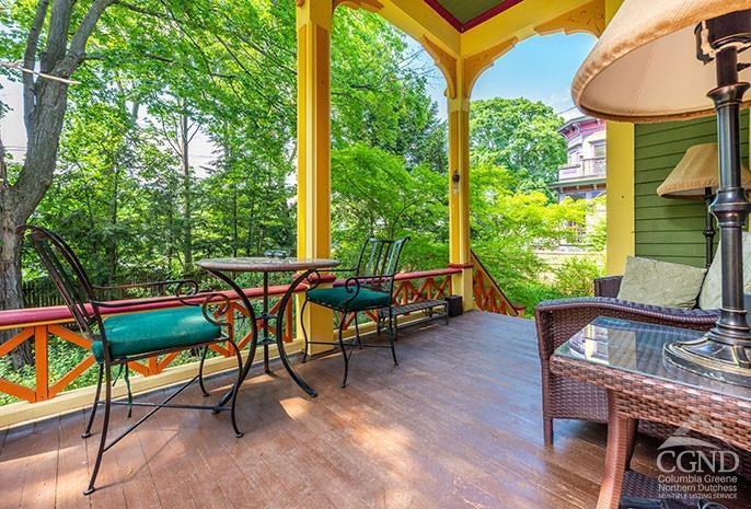 5 Willard Place Hudson, NY 12534 - Photo 21 of 26 a backyard of a house with wooden floor and outdoor seating