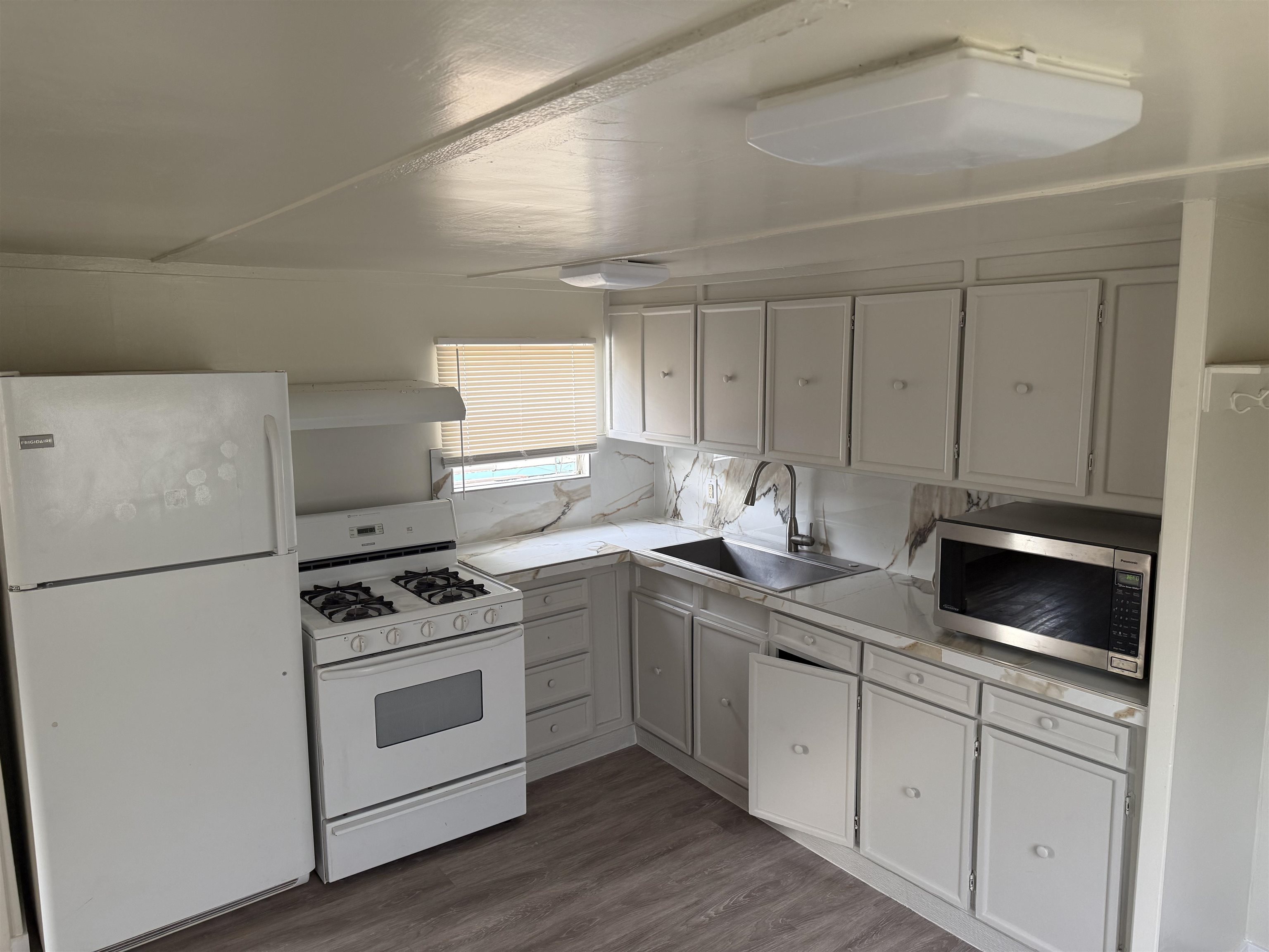585-25 25 1/2 Road, Unit 41 Grand Junction, CO 81505 - Photo 6 of 22 a kitchen with white cabinets stainless steel appliances and sink