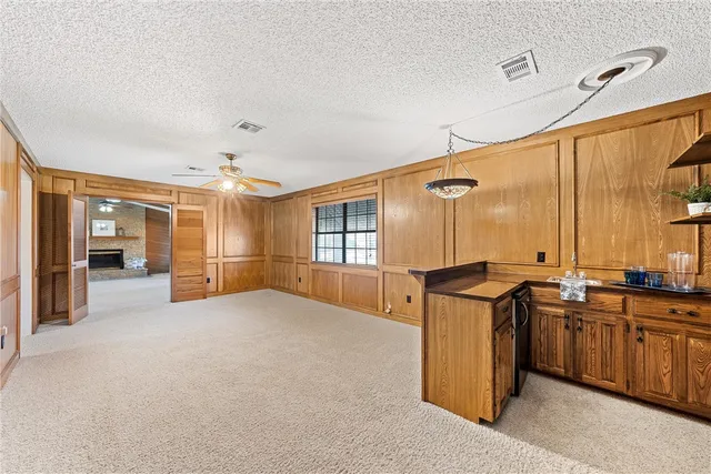 a kitchen with stainless steel appliances kitchen island granite countertop a table and chairs