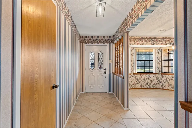a kitchen with a sink window and cabinets