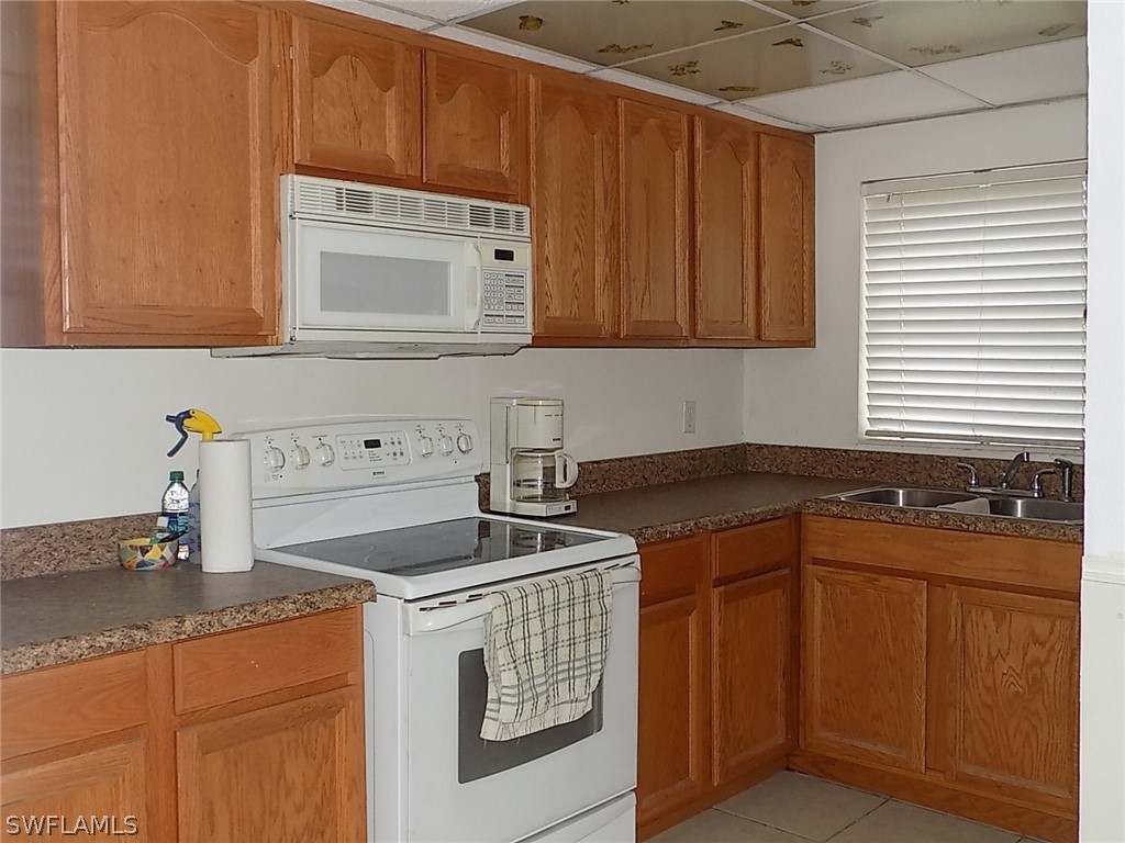 2105 Pineview Road Fort Myers, FL 33901 - Photo 16 of 22 a kitchen with granite countertop a sink stove and cabinets