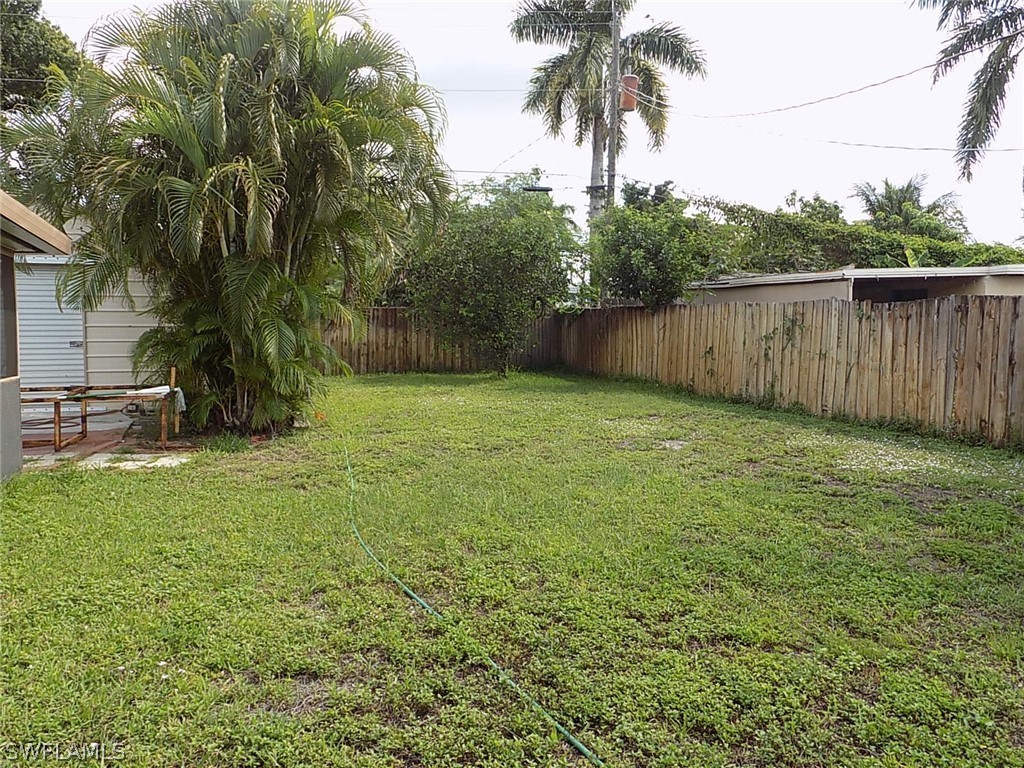 2105 Pineview Road Fort Myers, FL 33901 - Photo 20 of 22 a view of a backyard with potted plants and large trees
