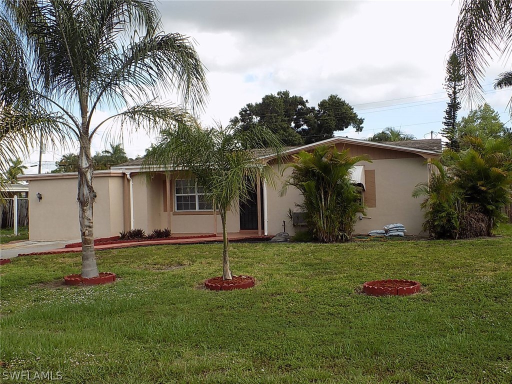 2105 Pineview Road Fort Myers, FL 33901 - Photo 4 of 22 a backyard of a house with potted plants and palm trees