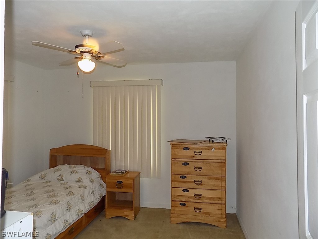 2105 Pineview Road Fort Myers, FL 33901 - Photo 9 of 22 a bedroom with a bed and cabinets