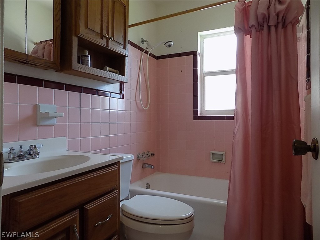 2105 Pineview Road Fort Myers, FL 33901 - Photo 10 of 22 a bathroom with a sink a toilet a mirror and shower