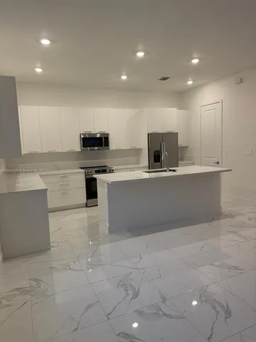 a bathroom with a sink a large mirror and a shower