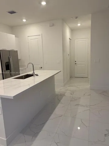 a bathroom with a glass shower door and a window