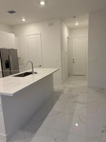 a bathroom with a glass door shower