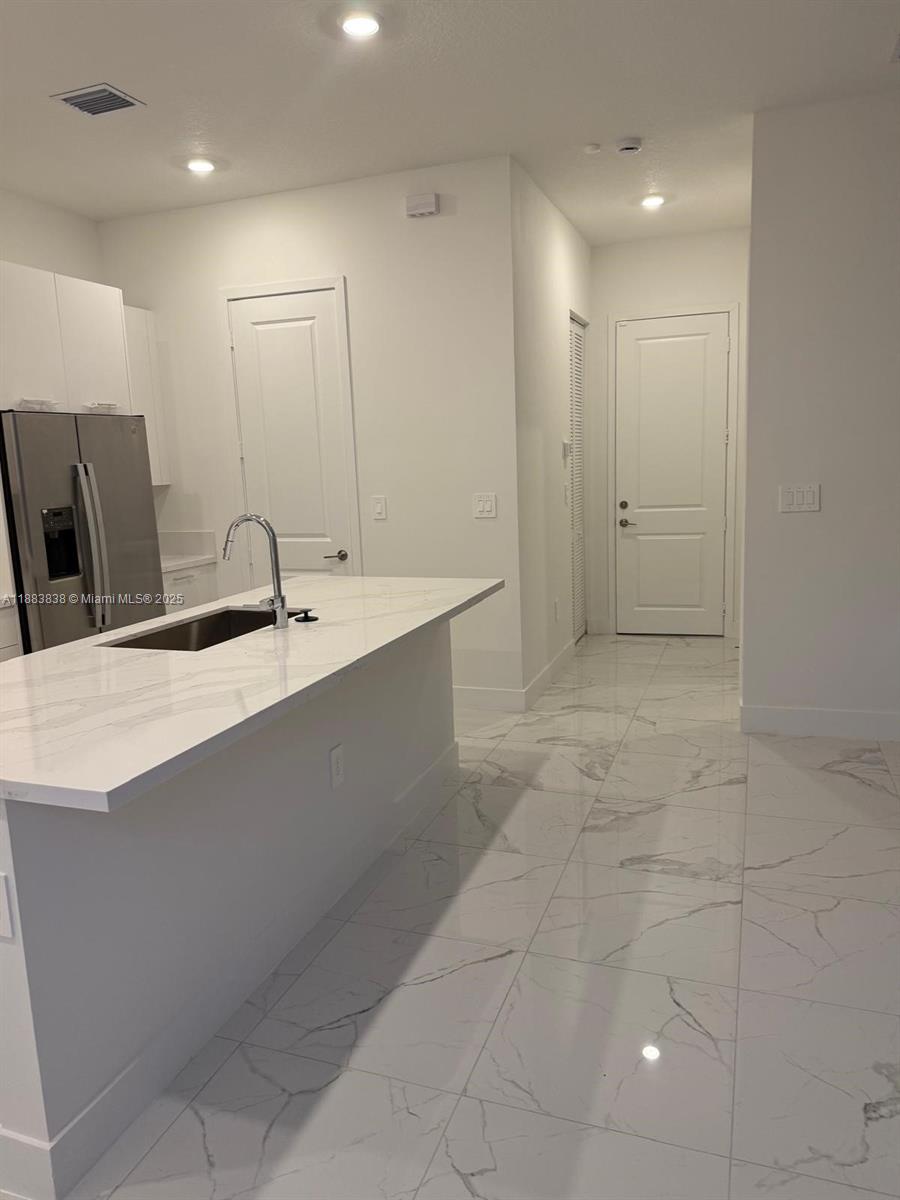 12303 Southwest 44th Street Davie, FL 33330 - Photo 15 of 42 a bathroom with a sink a large mirror and a shower