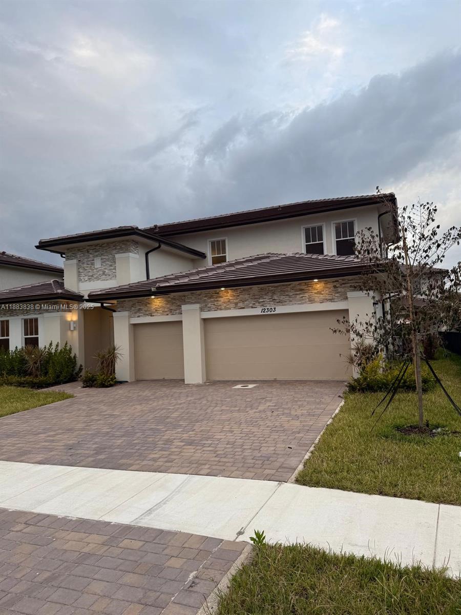 12303 Southwest 44th Street Davie, FL 33330 - Photo 2 of 42 a front view of a house with a yard
