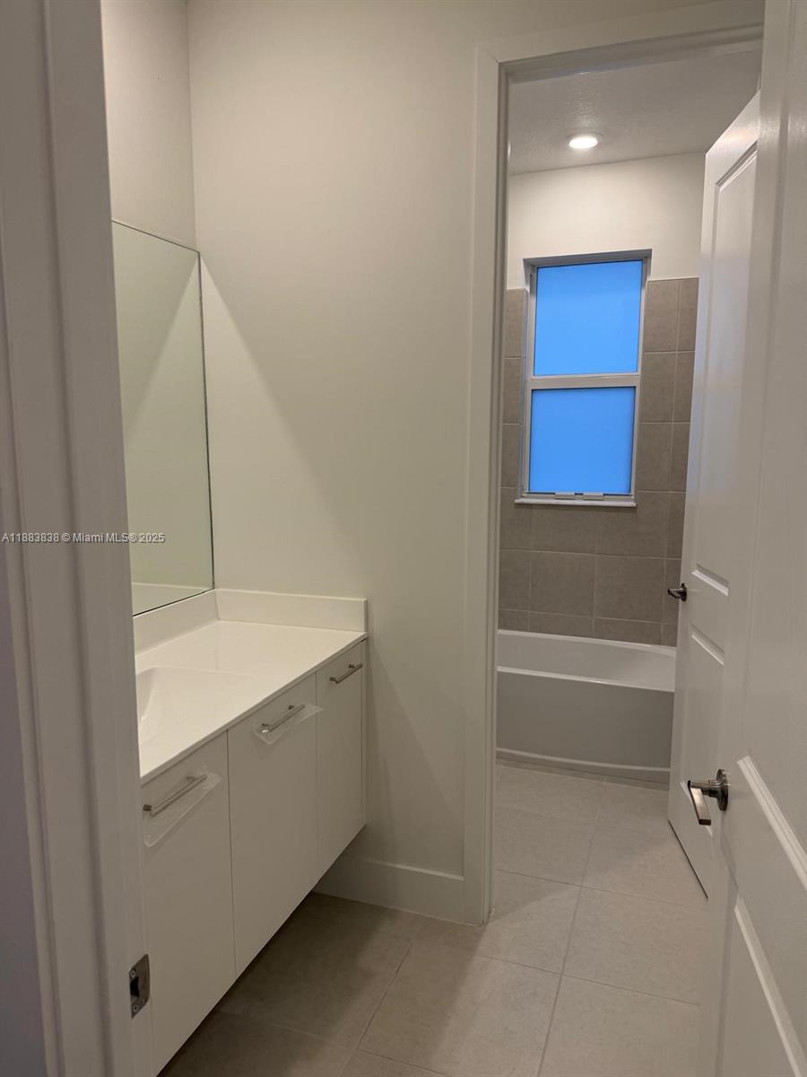 12303 Southwest 44th Street Davie, FL 33330 - Photo 30 of 42 a bathroom with a bathtub and a shower