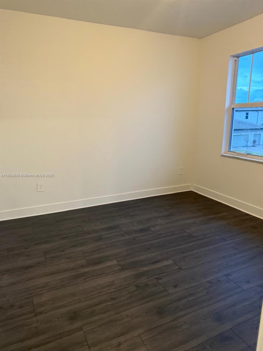 12303 Southwest 44th Street Davie, FL 33330 - Photo 36 of 42 a view of an empty room with wooden floor and a window