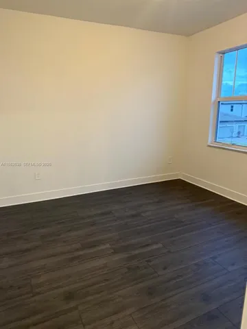 a bath tub sitting next to a white toilet and a shower