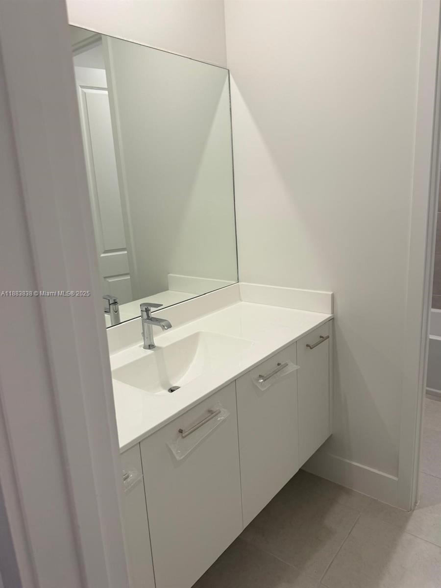 12303 Southwest 44th Street Davie, FL 33330 - Photo 38 of 42 a bathroom with a sink and a mirror