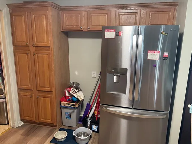 a kitchen with stainless steel appliances granite countertop a refrigerator and a sink