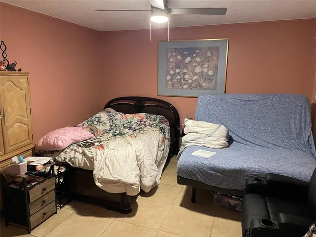 a bedroom with a bed and a painting on the wall