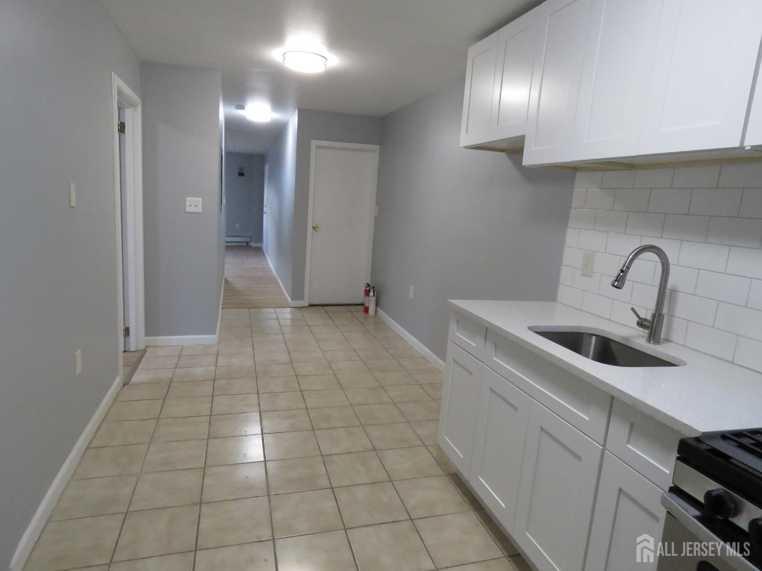 768 State Street Perth Amboy, NJ 08861 - Photo 16 of 35 a view of a kitchen with a sink and dishwasher in a kitchen