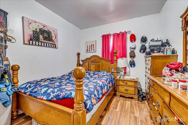 a view of bedroom with furniture and wooden floor