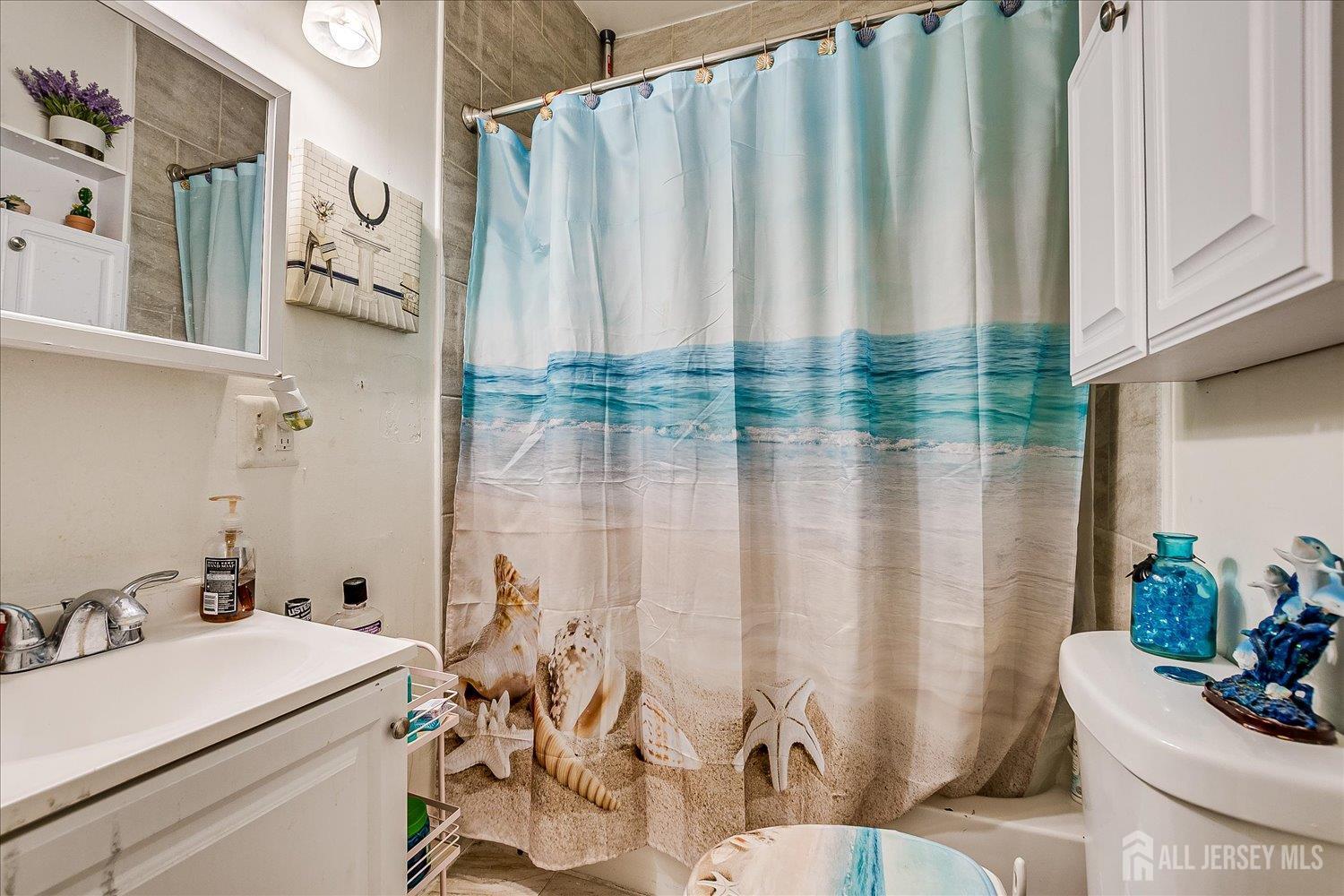 768 State Street Perth Amboy, NJ 08861 - Photo 22 of 35 a bathroom with a sink and a mirror