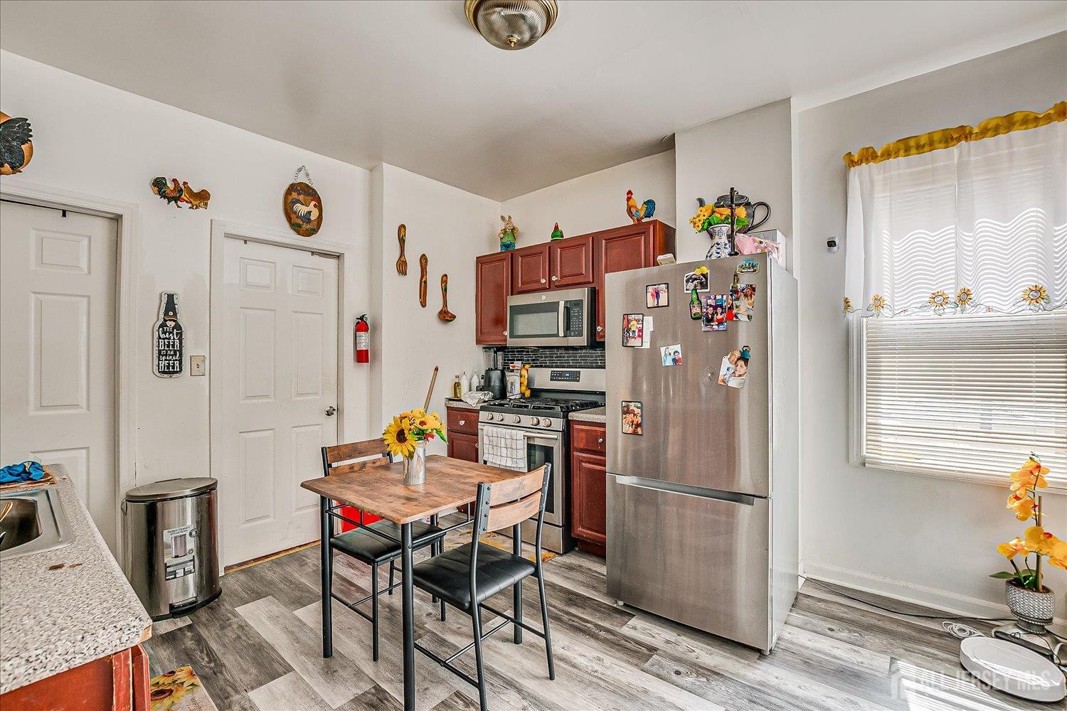 768 State Street Perth Amboy, NJ 08861 - Photo 24 of 35 a dining room with furniture a rug and a window