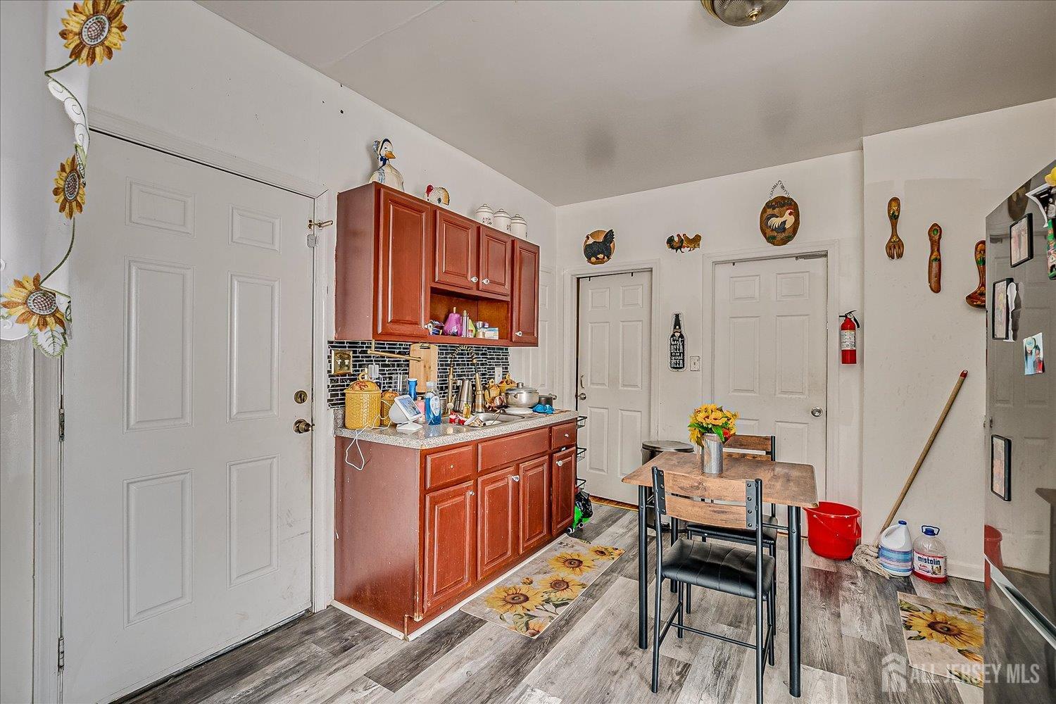 768 State Street Perth Amboy, NJ 08861 - Photo 26 of 35 a kitchen that has a lot of fruit on it and wooden floor