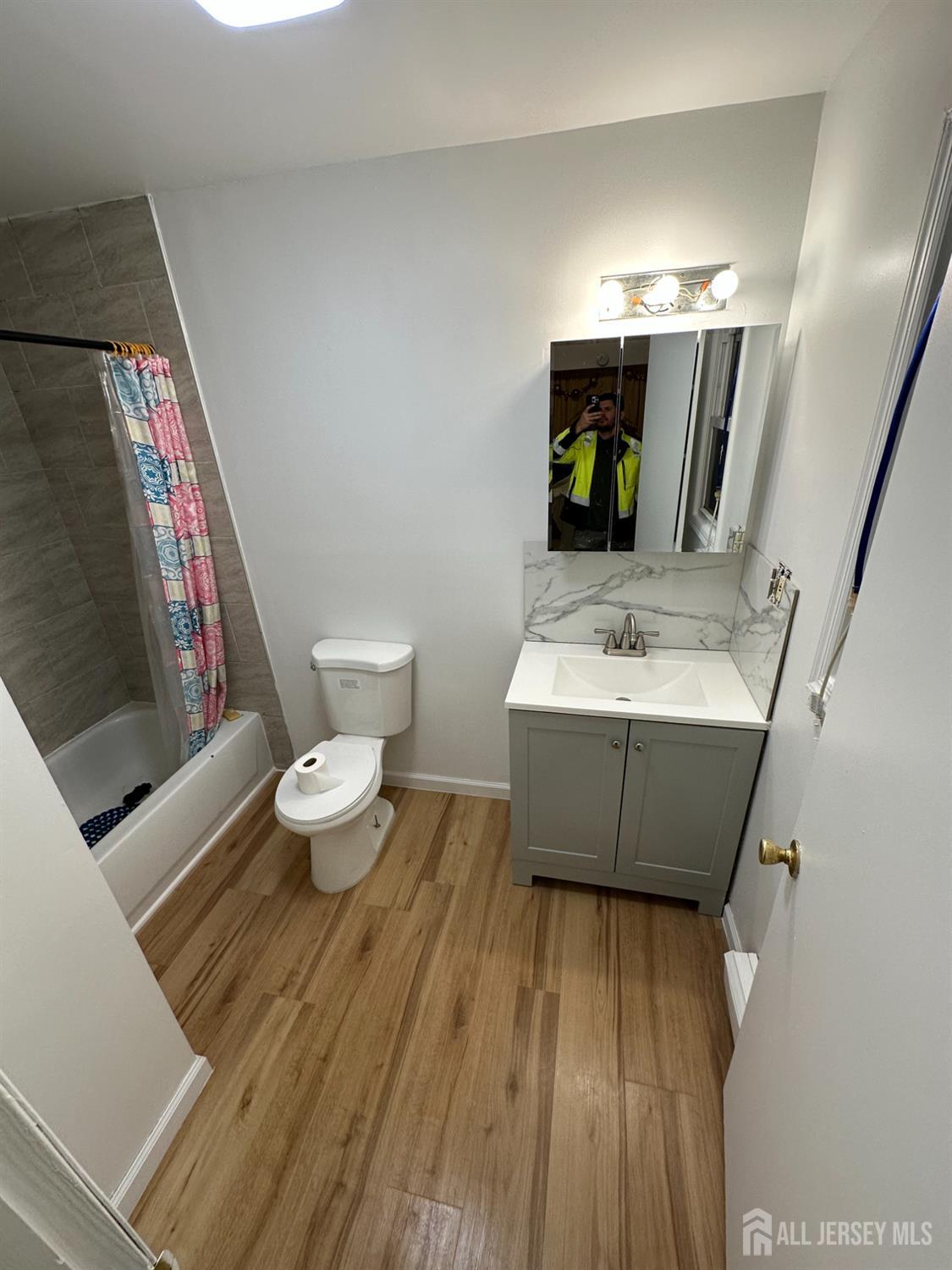 768 State Street Perth Amboy, NJ 08861 - Photo 34 of 35 a bathroom with a sink and a mirror