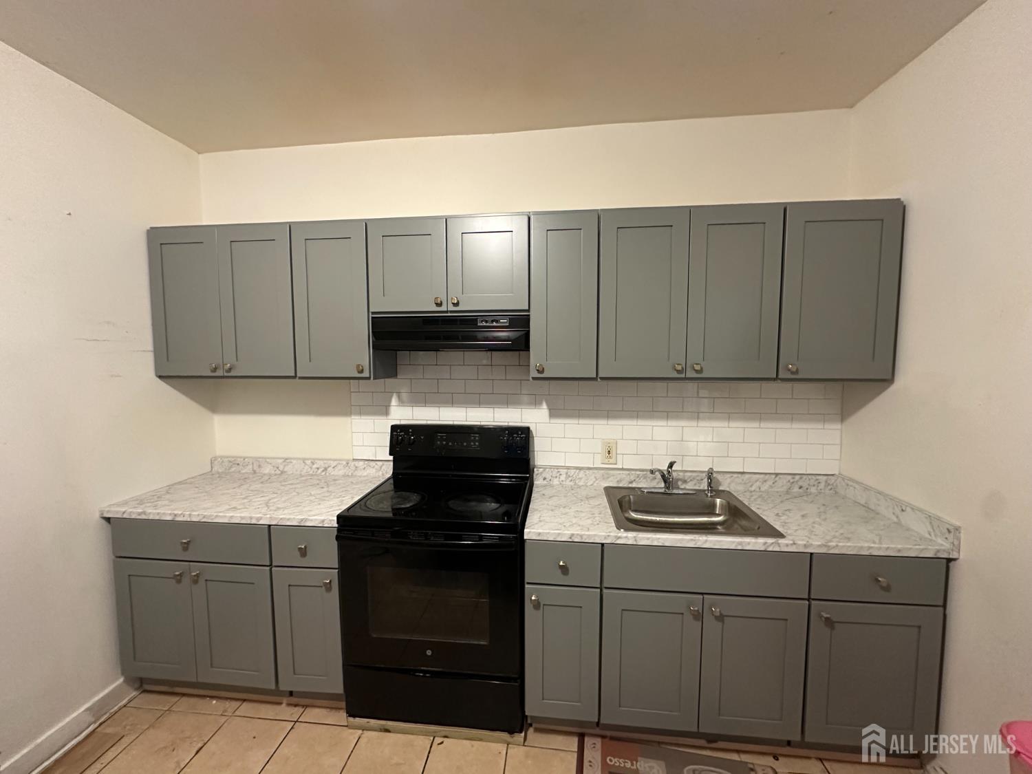 768 State Street Perth Amboy, NJ 08861 - Photo 35 of 35 a kitchen with granite countertop a sink cabinets and stainless steel appliances