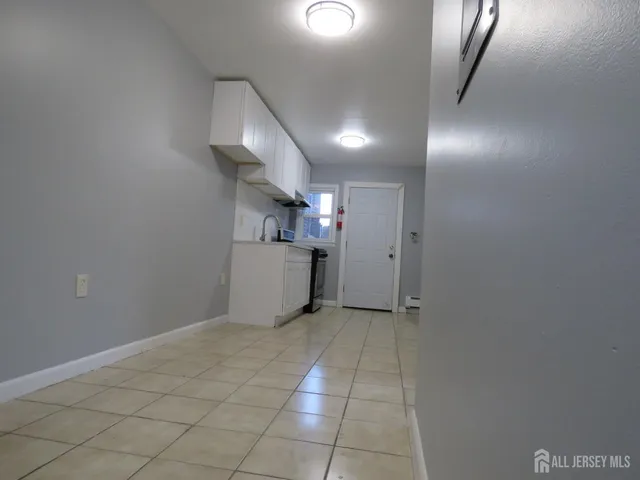 a kitchen with cabinets appliances and a sink