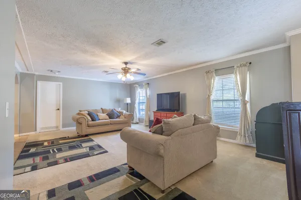 a living room with furniture and a flat screen tv