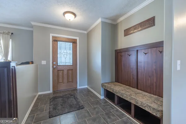 a view of a dining room with furniture chandelier and wooden floor