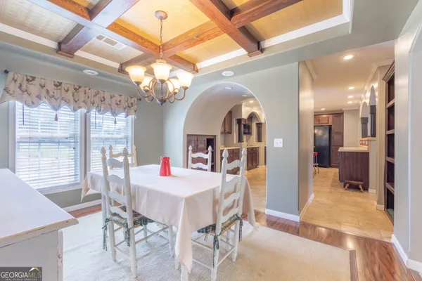 a kitchen with stainless steel appliances granite countertop a sink a stove and a wooden floors