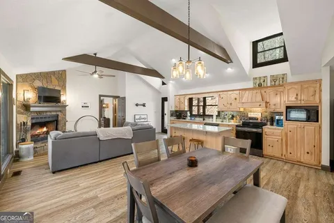 a living room with furniture and kitchen view