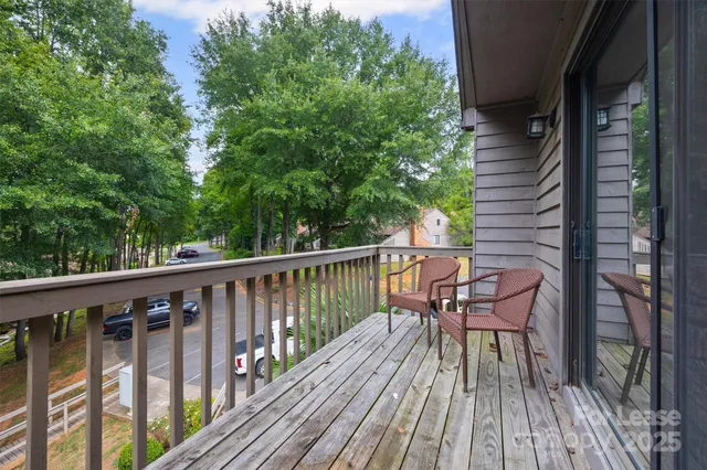 a balcony with wooden floor and fence