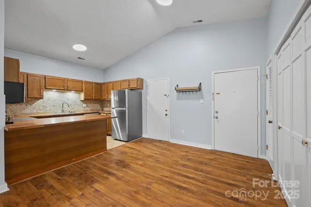 a kitchen with stainless steel appliances a refrigerator and a stove