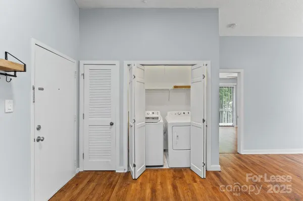 a view of empty room with wooden floor and fireplace