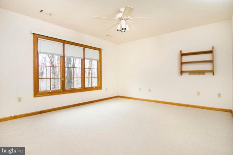4820 Mt Zion Road Frederick, MD 21703 - Photo 14 of 27 an empty room with a window and a ceiling fan