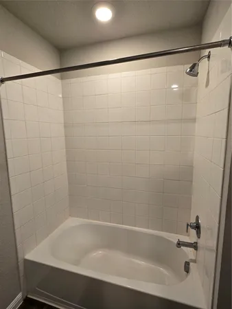 a bathroom with a shower and a bathtub