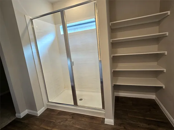 a view of walk in closet with empty racks