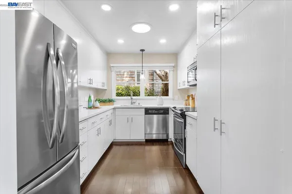 a kitchen with stainless steel appliances a refrigerator sink and stove