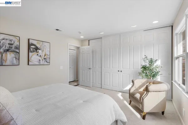 a bedroom with a bed and a couch