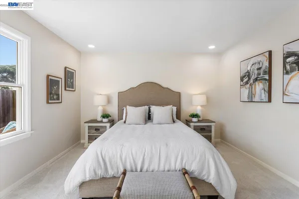 a bedroom with a large bed and a chandelier